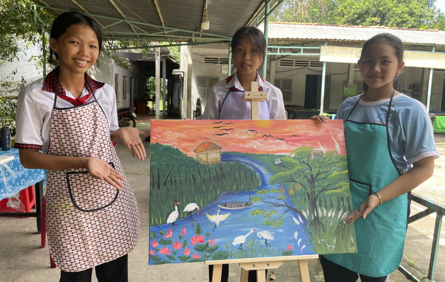 Three winners of the contest showed their canvas painting on wetlands ecosystems