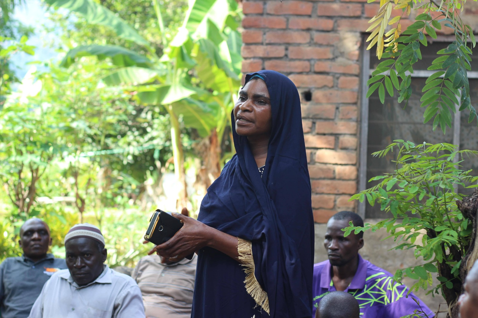 A woman member from farmers organisation of the Mkula Irrigation Scheme contributing to a meeting