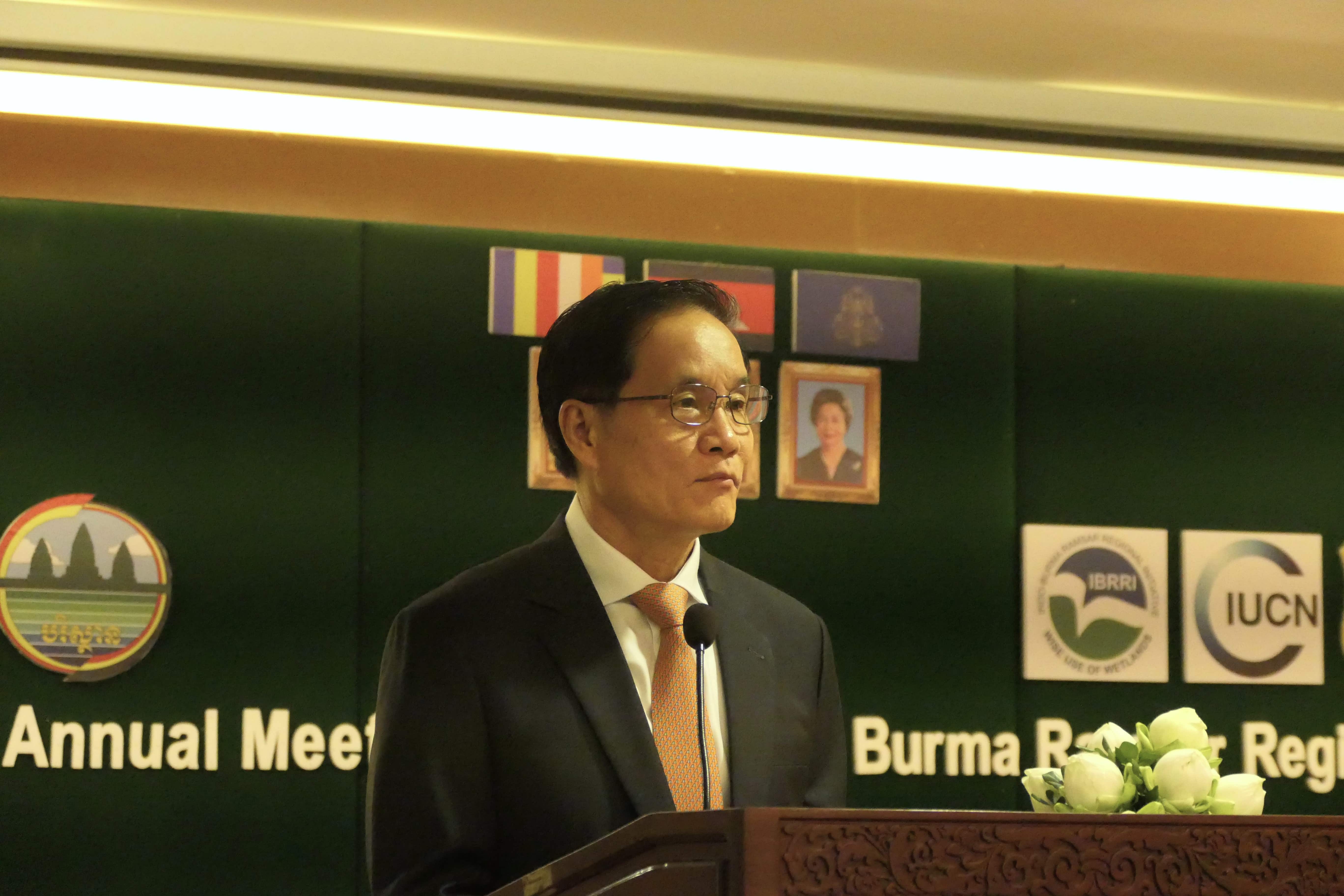 Secretary of State, Ministry of Environment, gives opening remarks on a podium