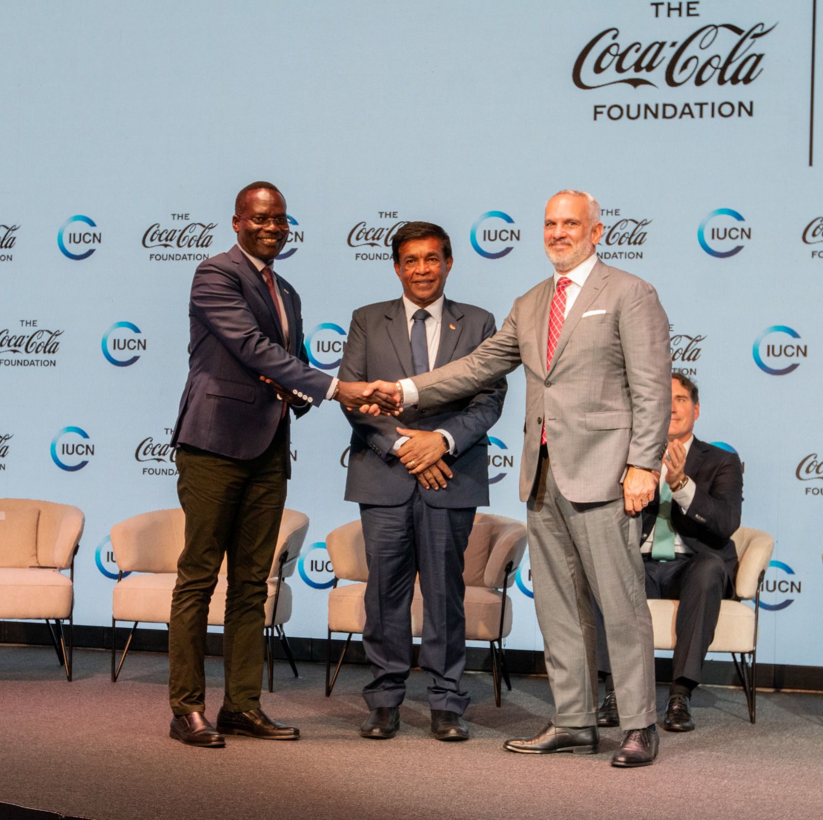A handshake between IUCN ESARO and the Coca-Cola Foundation Heads