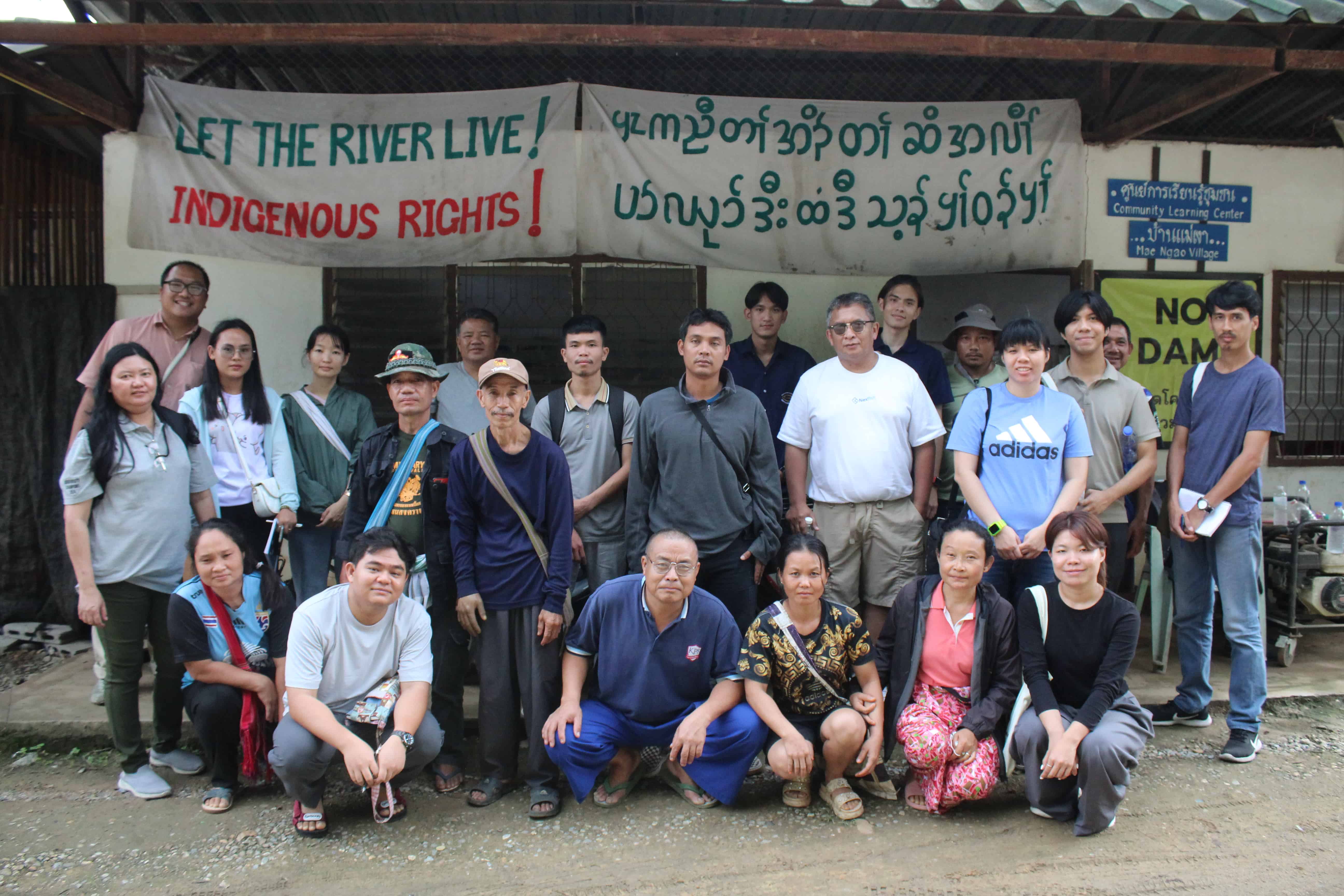 Group of participants standin in front of "Let the river live" sign