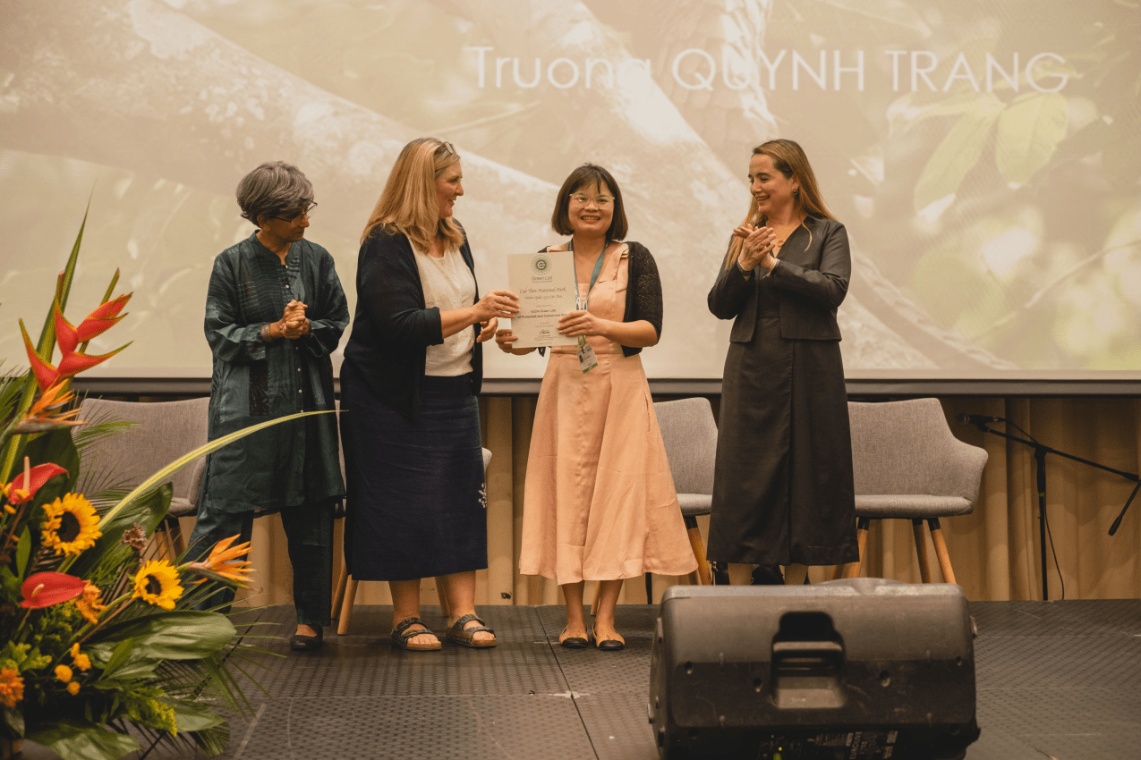A participant at the Green List Awards collects her site's certificate.