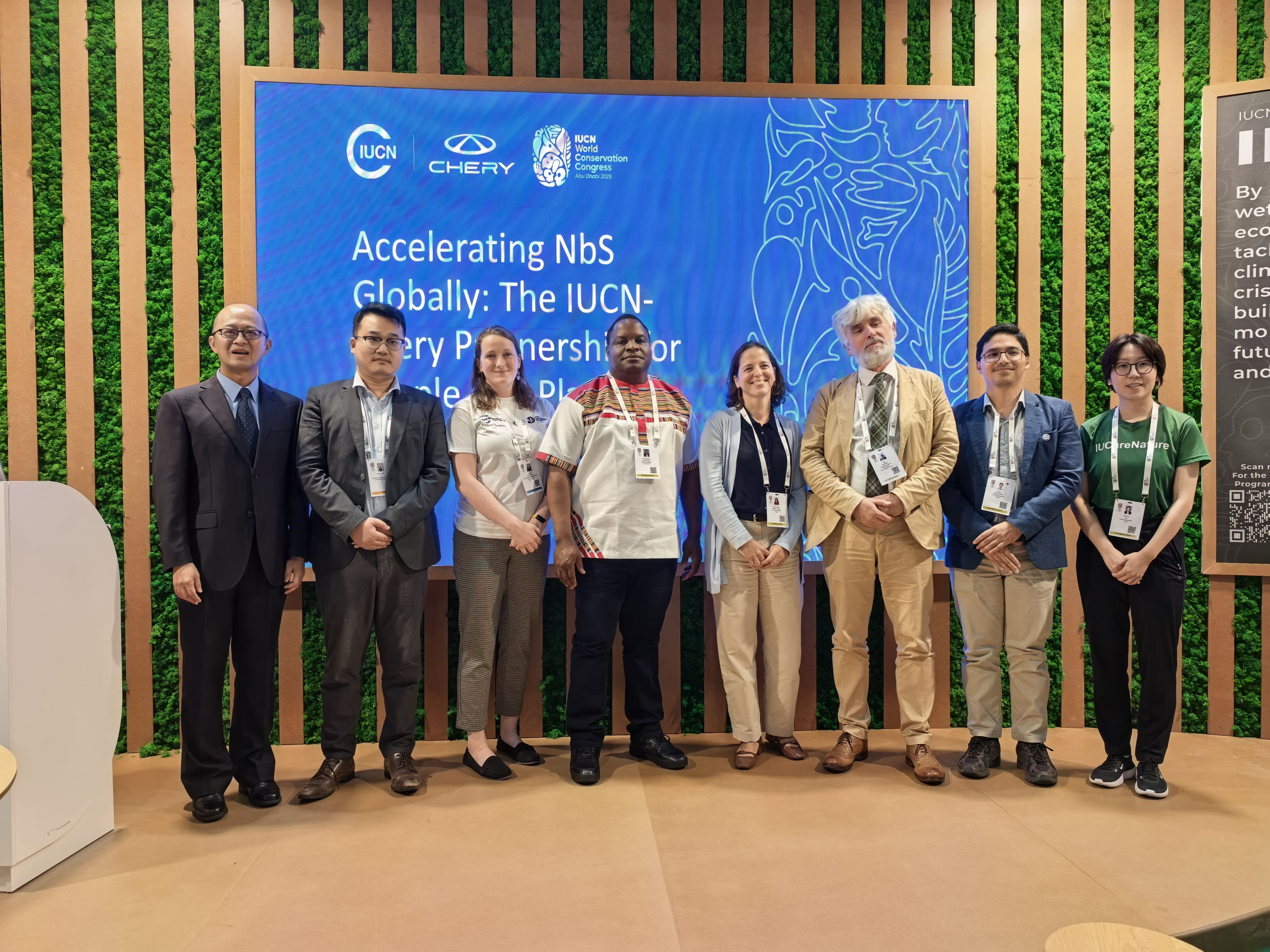 Group of people standing in a row and smiling at the camera