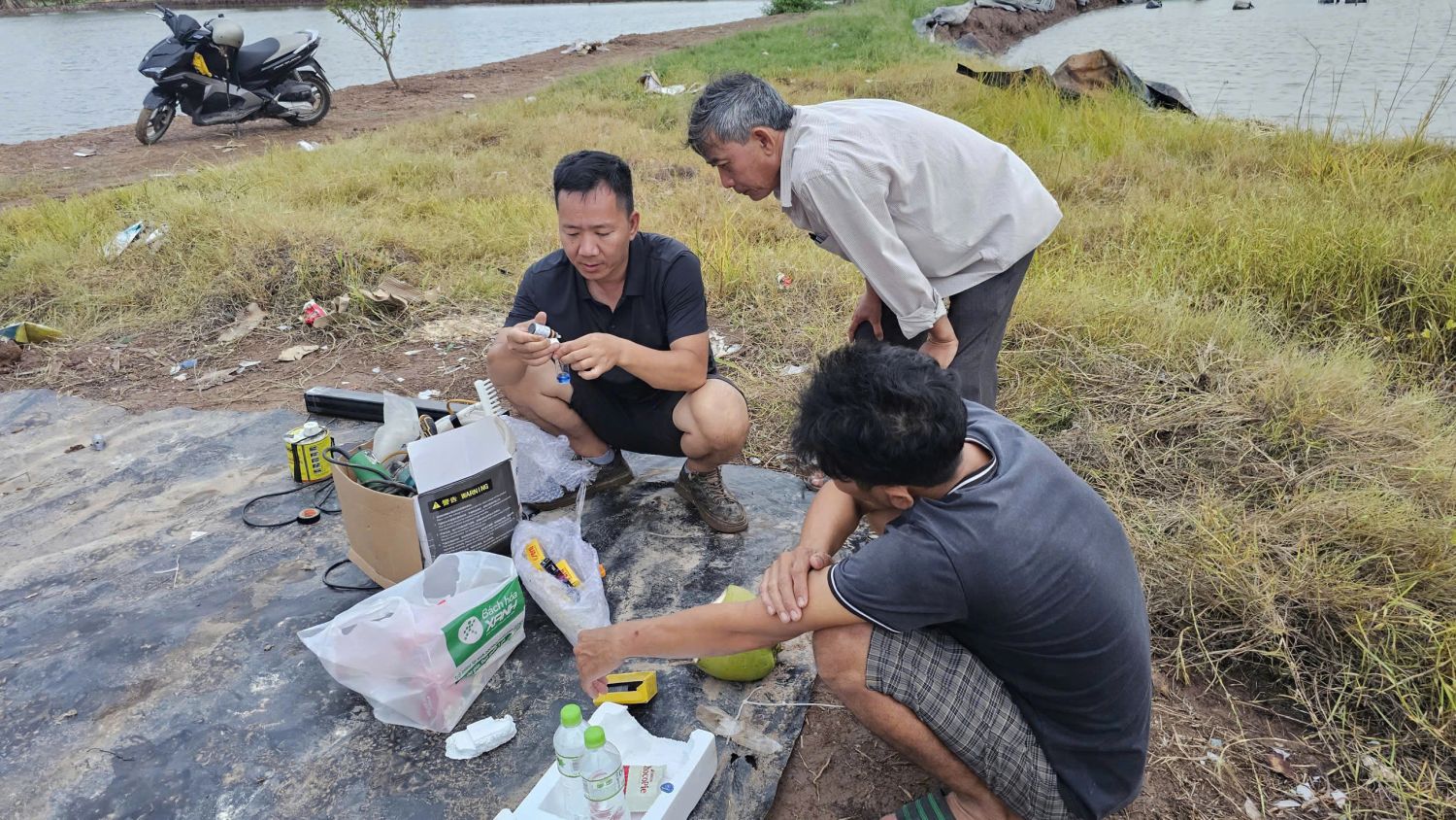 Trainer guides households through hands-on water quality testing, demonstrating the use of test kits to measure pH, alkalinity, hardness, and ammonia levels