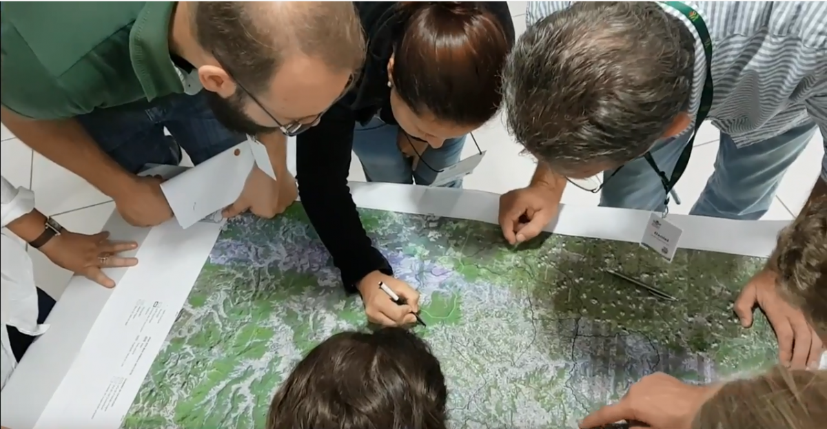 people looking around a map