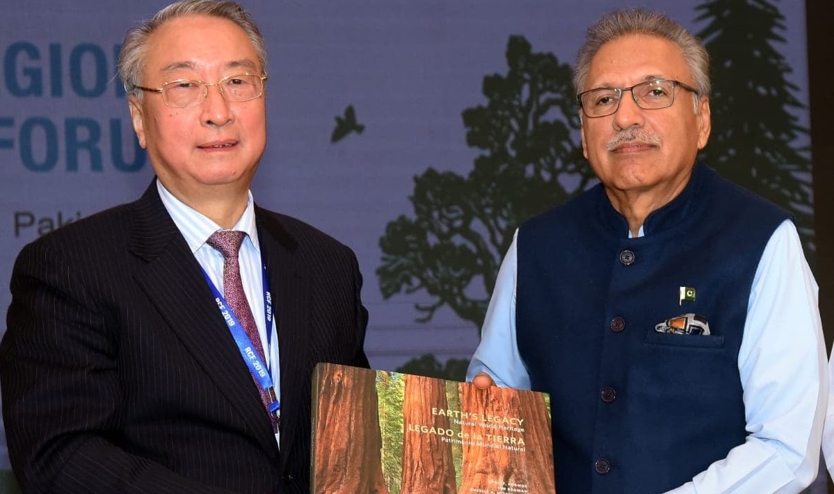 IUCN President Zhang Xinsheng presents the Earth's Legacy: Natural World Heritage publication as token of gratitude to President Arif Alvi for co-hosting the Asia RCF in Islamabad, Pakistan