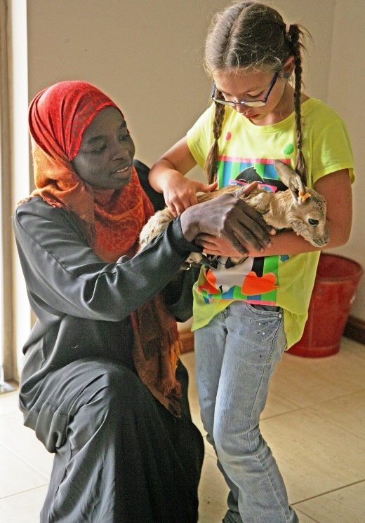 Wilderness leader / environmental educator Aishah Abdallah explaining care of a gazelle fawn to a student