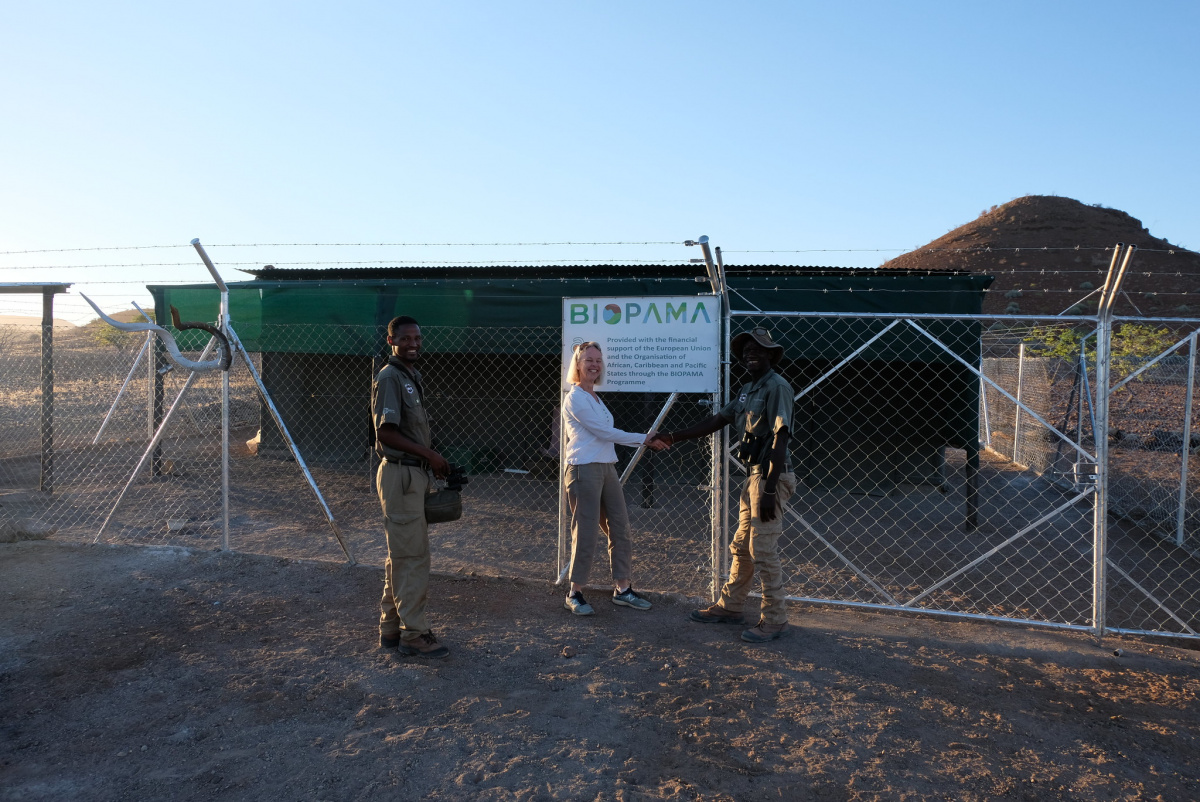 BIOPAMA ESA Coordinator and a rhino ranger in front of an upgraded fly camp in Namibia