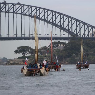 The Mua Voyage vaka canoes about to sail under the Sydney Harbour Bridge