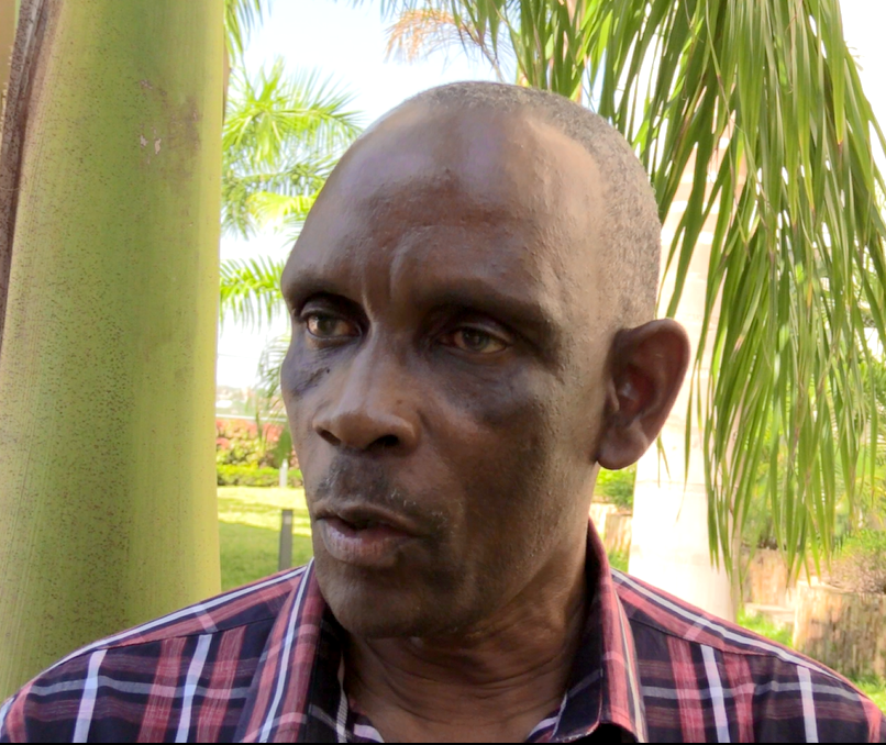 man in front of palm talking