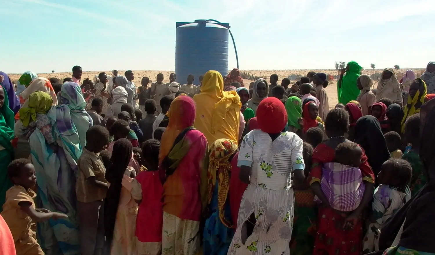 Displaced persons waiting at a water tank in Geneina, West Darfur, in 2007.