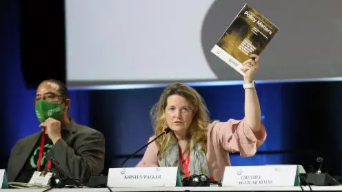 Kristen holding CEESP publication on Environmental Defenders launched at WCC