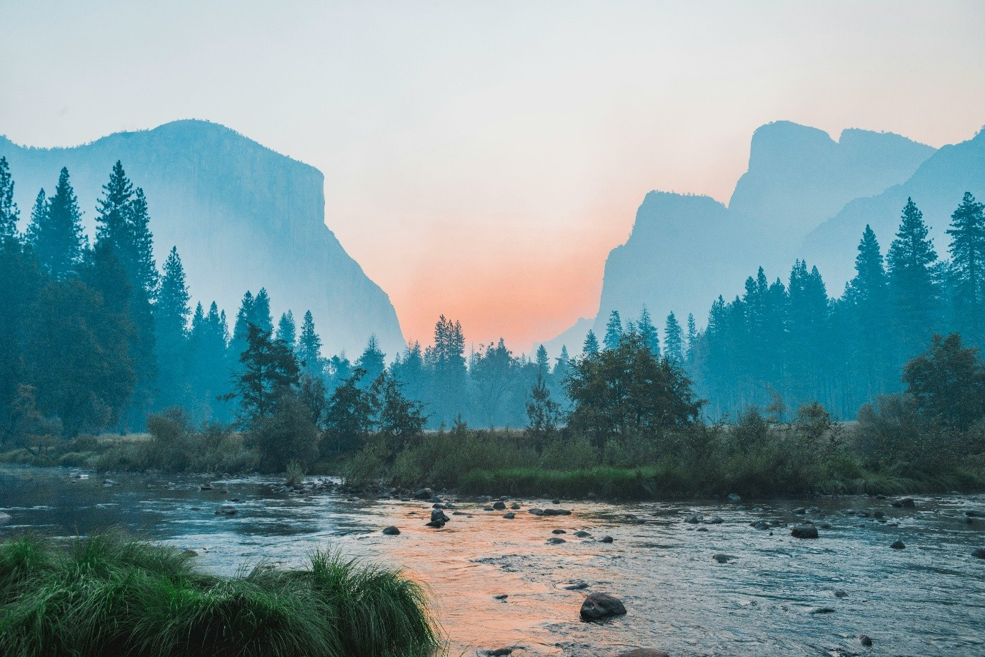River flowing with mountains in the background