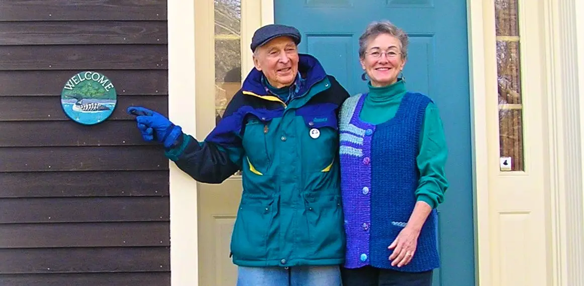 Larry Hamilton outside his home in Vermont, with Linda.  The Welcome is typical