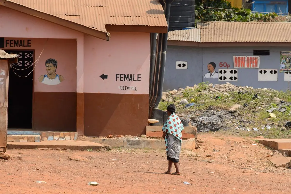 Unidentified Ghanaian woman walks towards sanitation facilities