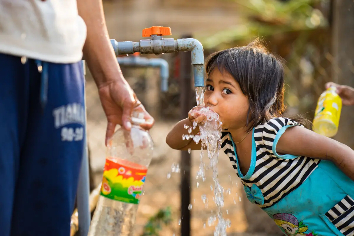 Child drinks water from tap, Viet Nam