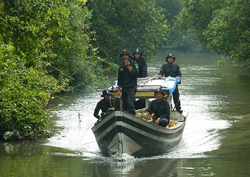 Sumatran Rhino Protection Units (RPUs) patrolling the Way Kanan River in Way Kambas NP.