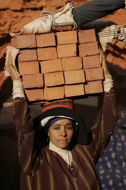 Egyptian woman carrying bricks
