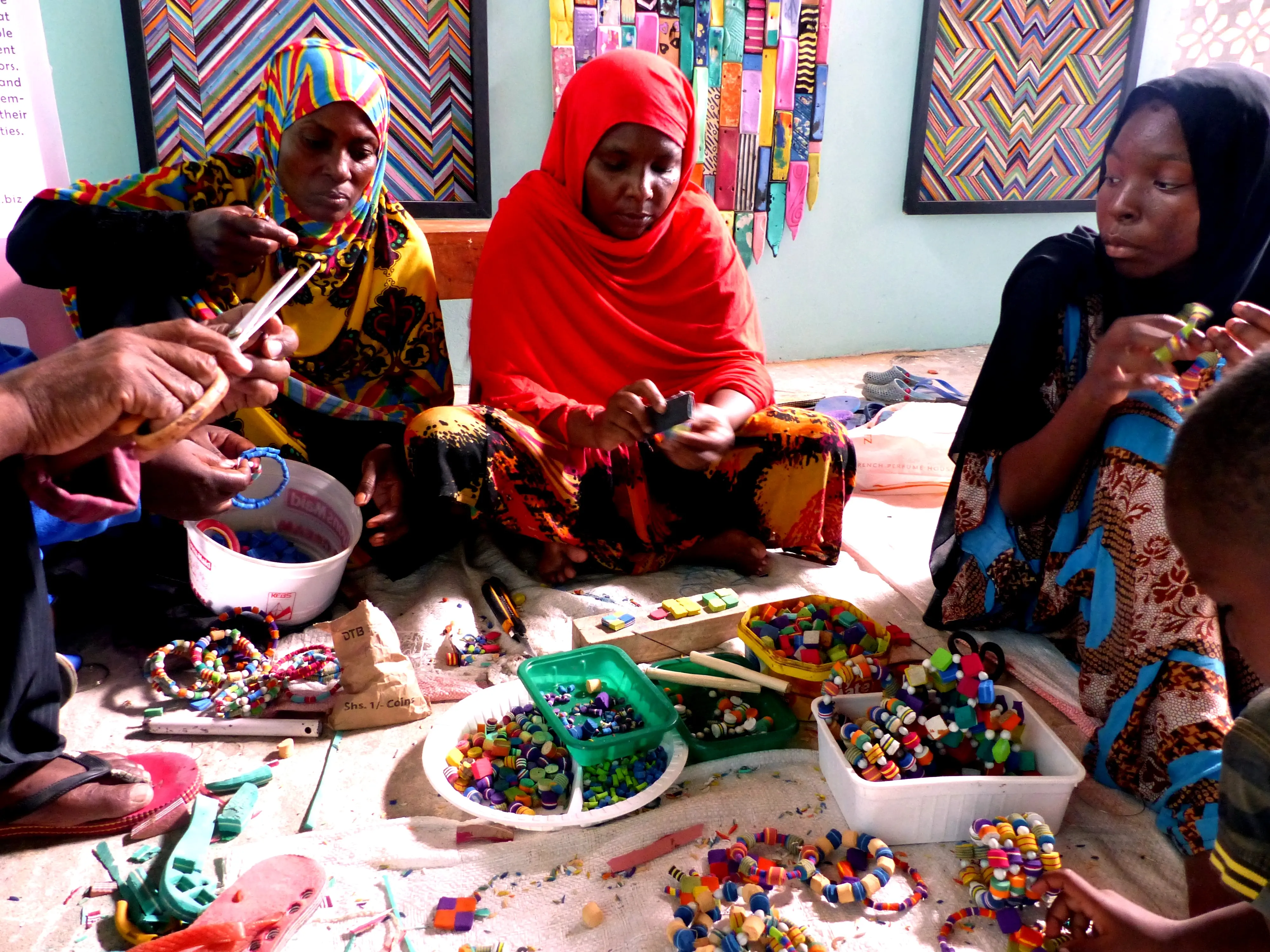 Women making jewelry from recycled flip flops