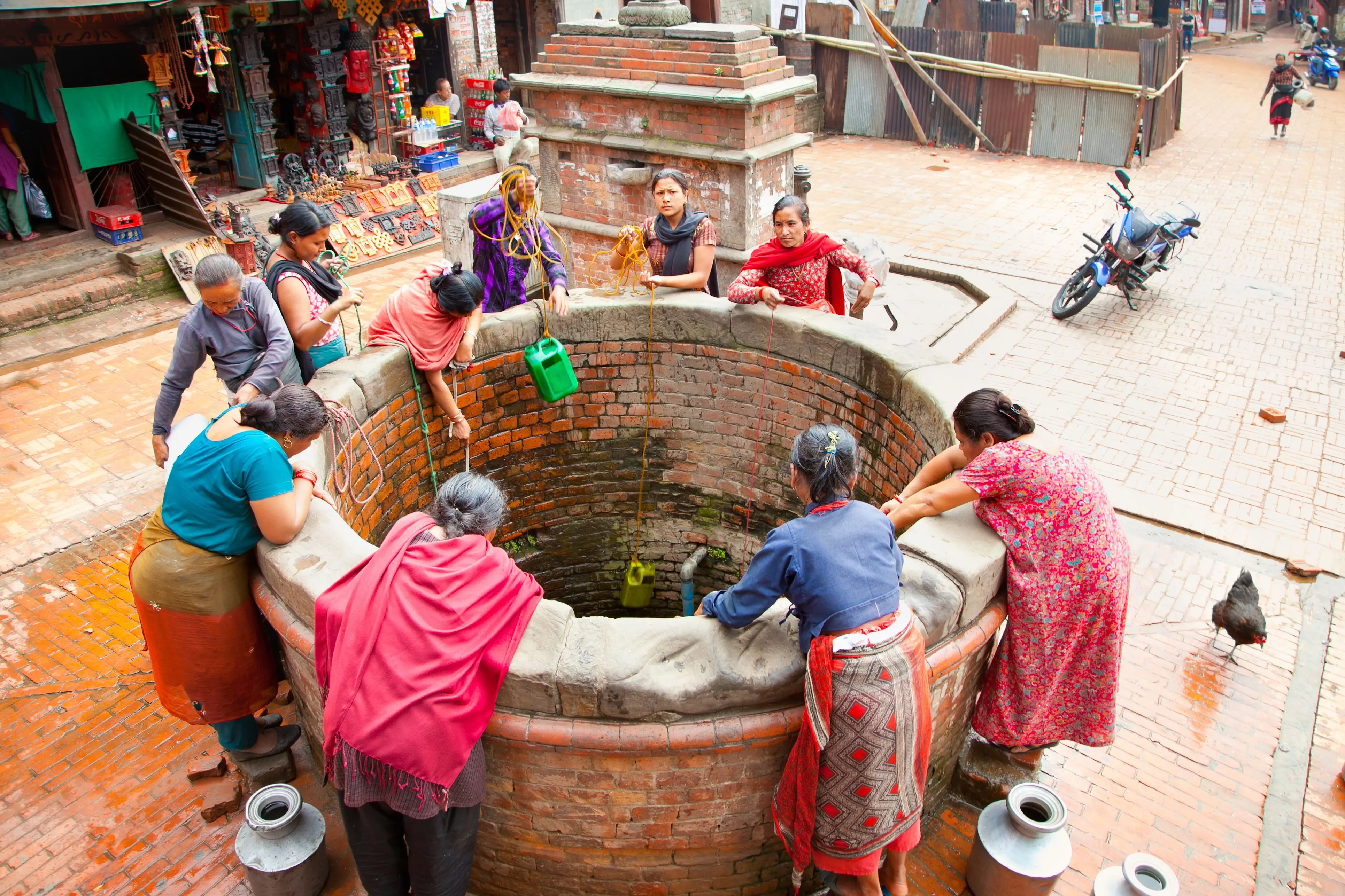 Women draw water from a well, Nepal